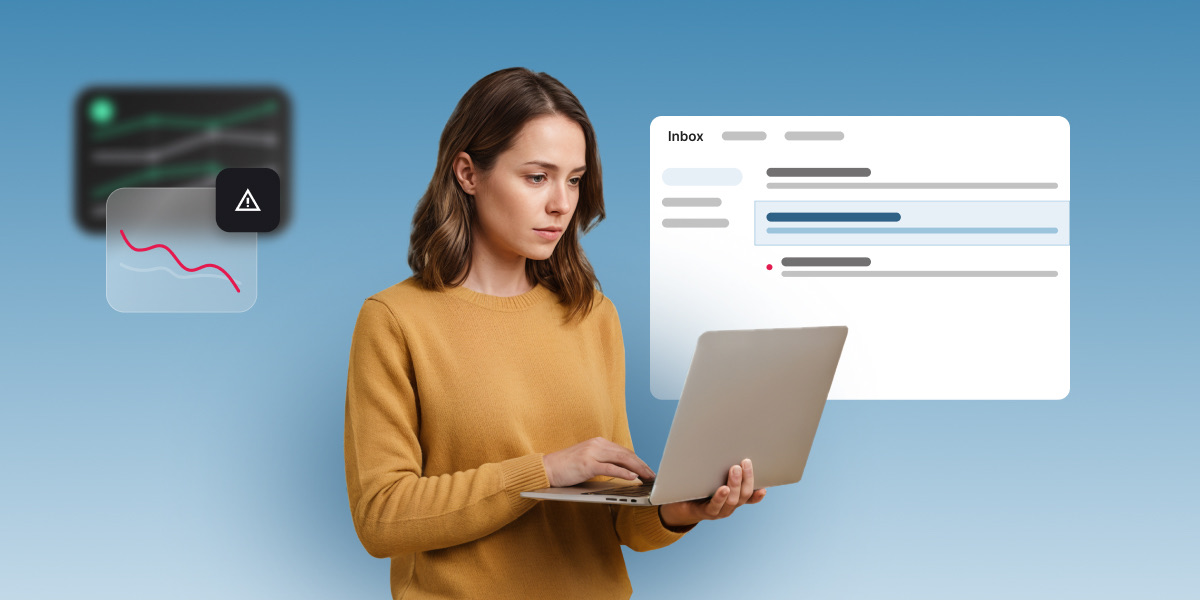 Woman reviewing declining email performance charts and inbox warning signs on a laptop