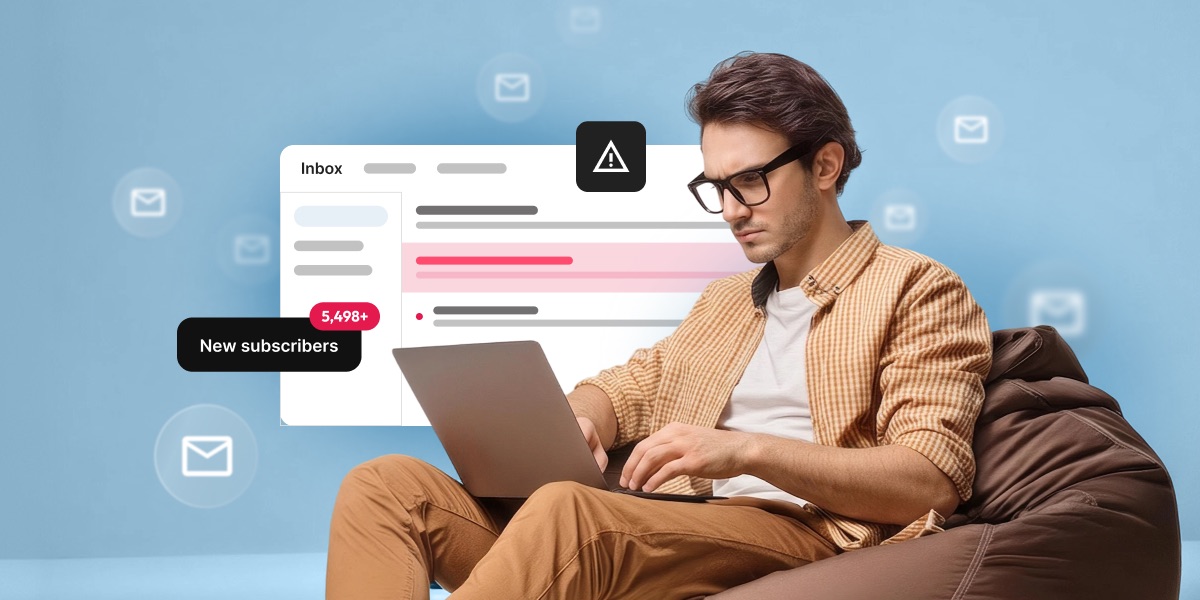 Man sitting on a bean bag chair looking concerned at his laptop, with an inbox showing a flagged email and a notification reading "5,498+ New subscribers."